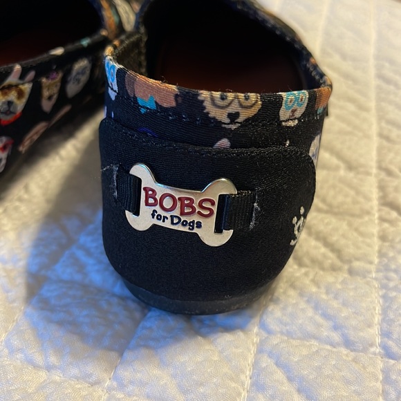 BOBS By Skechers slip on shoes in black with various dog designs on the shoes. - Picture 3 of 8